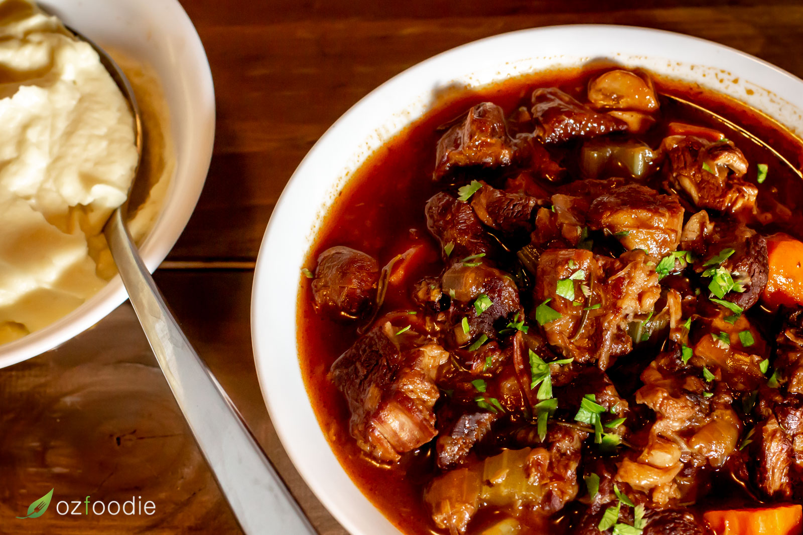 Beef stew in a bowl with a side of cauliflower mash